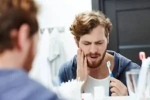 man with sensitive tooth